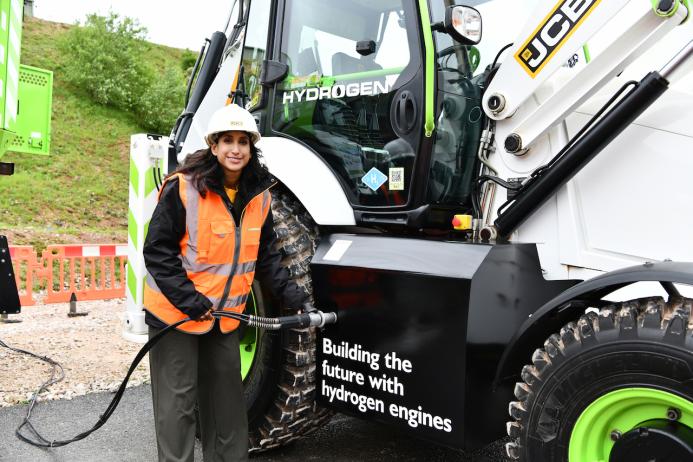 The Secretary of State for Energy Security and Net Zero, Claire Coutinho MP, tries her hand at the quick and easy task of refuelling a JCB backhoe loader with hydrogen