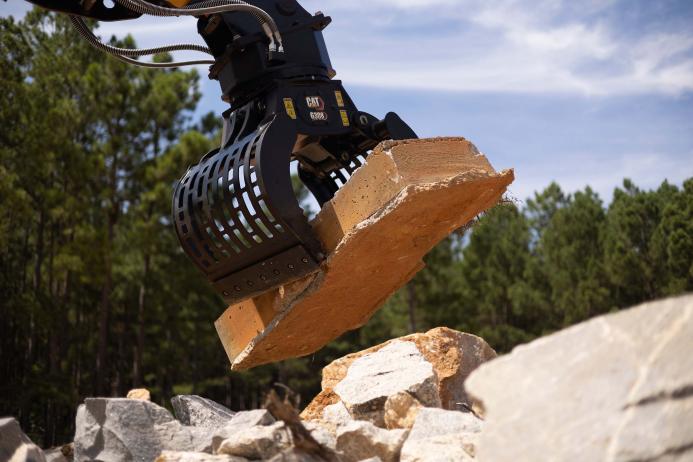 Cat G308 sorting grapple in operation 