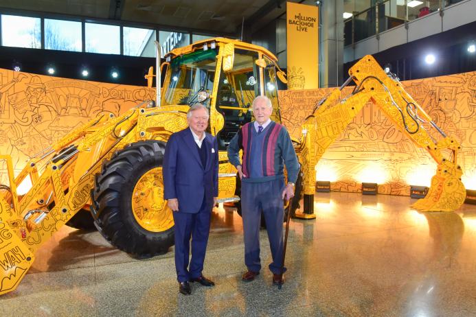JCB chairman Lord Bamford with retired employee Ken Harrison and the millionth backhoe to be produced