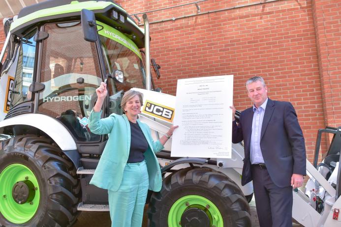 Lilian Greenwood and JCB’s Tim Burnhope with the signed statutory instrument