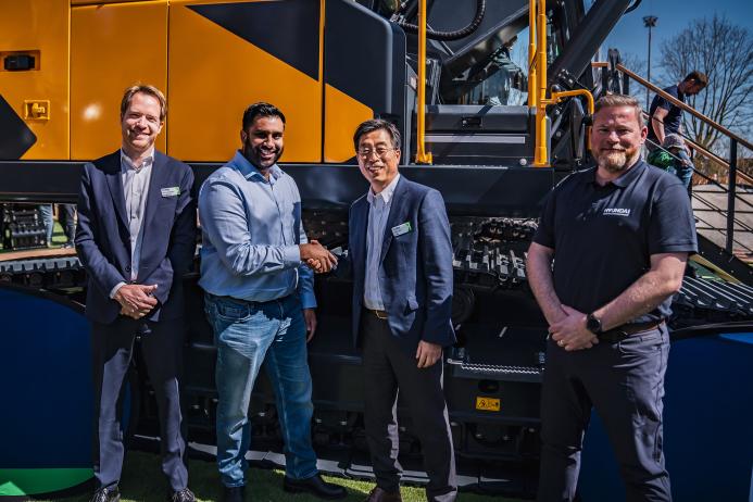 Rygor Group commercial director Rish Channa (centre left) and Chase Shim, managing director of Hyundai Construction Equipment Europe (centre right), shake hands on the appointment of Rygor Plant at the Bauma fair in Munich, with Bart van Berkel, network excellence development (left) and Anthony Hogben, regional sales manager (right)