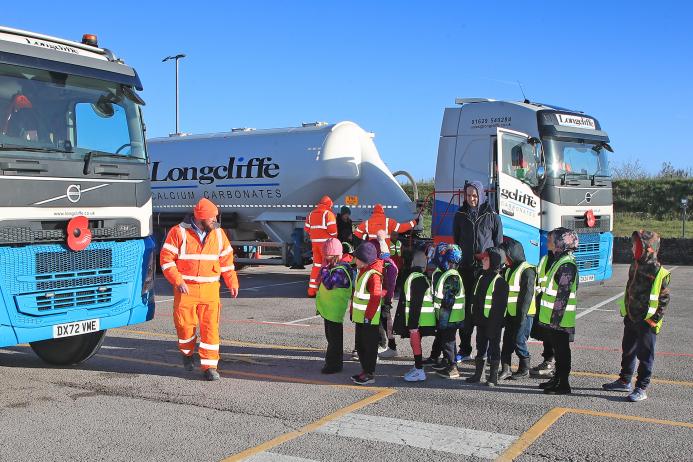 Cromford Primary School students are taken through road safety exercises with Longcliffe health and safety manager Tony Woodroffe (left)