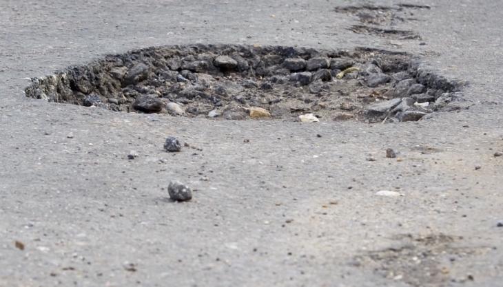 The AIA says the extra £420 million for local road maintenance is not enough Pothole