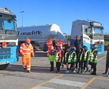 Cromford Primary School students are taken through road safety exercises with Longcliffe health and safety manager Tony Woodroffe (left)