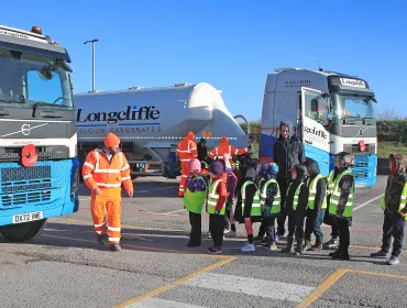 Cromford Primary School students are taken through road safety exercises with Longcliffe health and safety manager Tony Woodroffe (left)