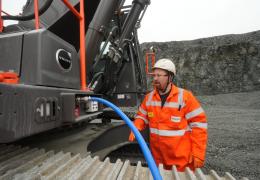 Rhys Morgan, Chepstow Plant engineer at Tarmac’s Dolyhir and Gore quarries, demonstrating the ground-level AdBlue refuelling system on the new Volvo EC500F excavator   