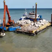 Rock armour from Glensanda was shipped to the east coast where the boat anchored at sea, with a smaller barge transporting approximately 1,000 tonnes of aggregates to the beach twice a day at high tide