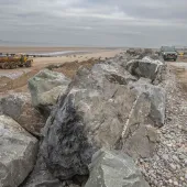 Granite armour-stone is being used to help strengthen vital sea defences at Kinmel Bay 