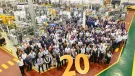 JCB Power Systems employees celebrate the company’s 20th birthday at the plant in Foston, Derbyshire